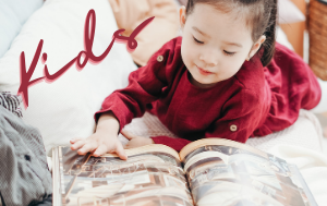Image of young child reading with the word kids as its identifier